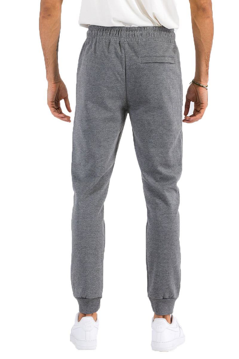 Person wearing gray sweatpants on a white background
